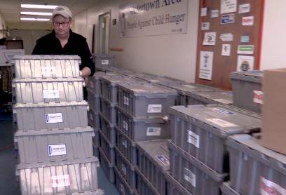 Tom Beadnell pushing boxes of children's backpack packs.