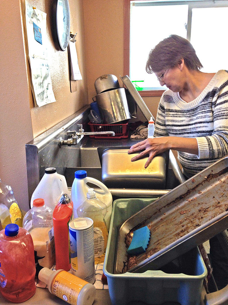 Kitchen cleanup at the Warm Welcome in Mission