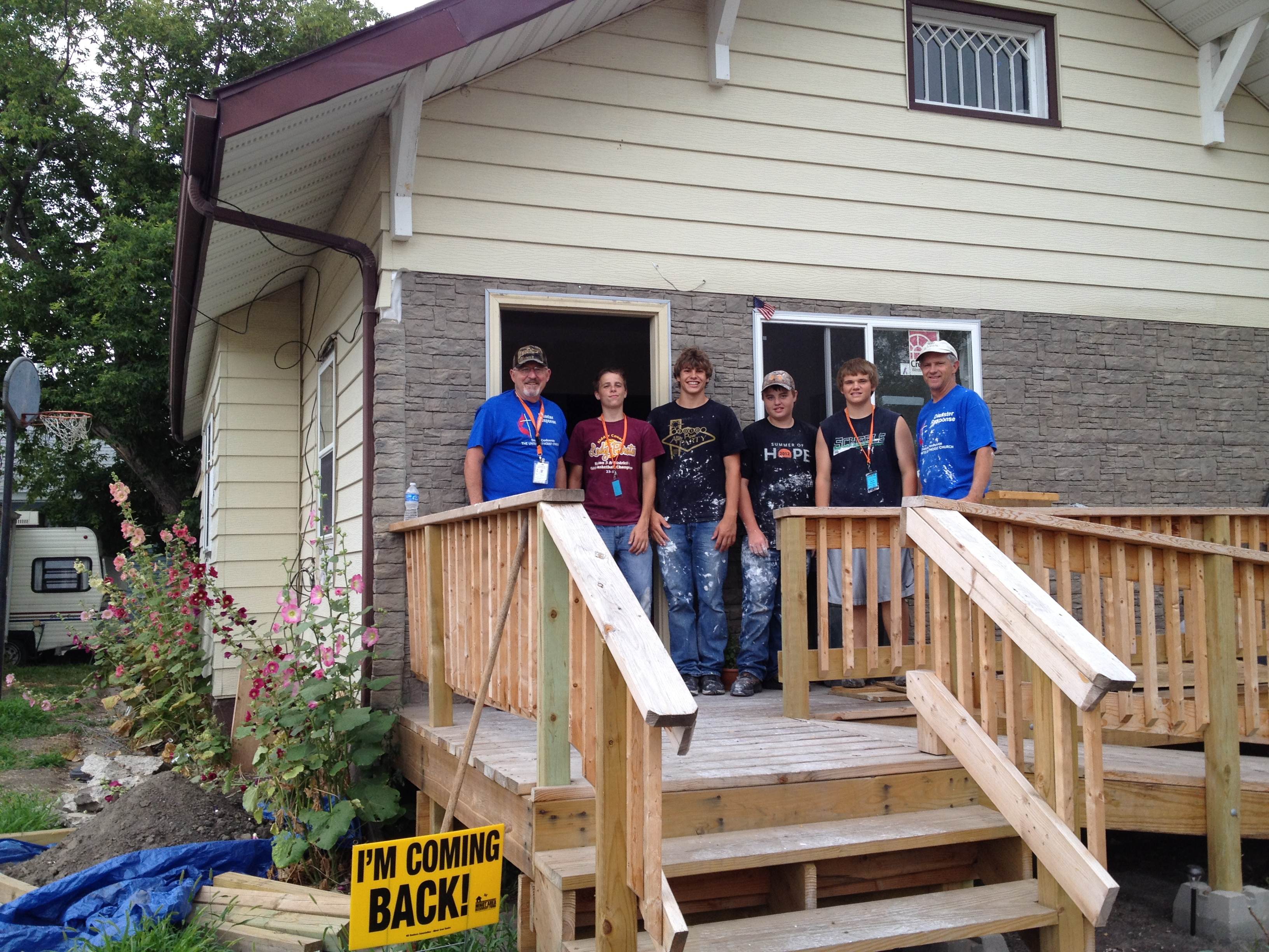 Bob Lower, Associate Coordinator for Disaster Relief Minot Area poses after a long day's work with youth from Minnesota.