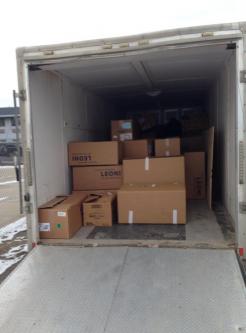 Shoebox Christmas gifts loaded into trailer for distribution.