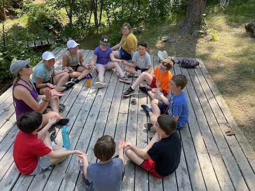 group of campers sitting on platform