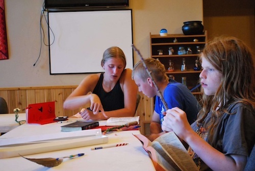 Abby Ferris at table with campers