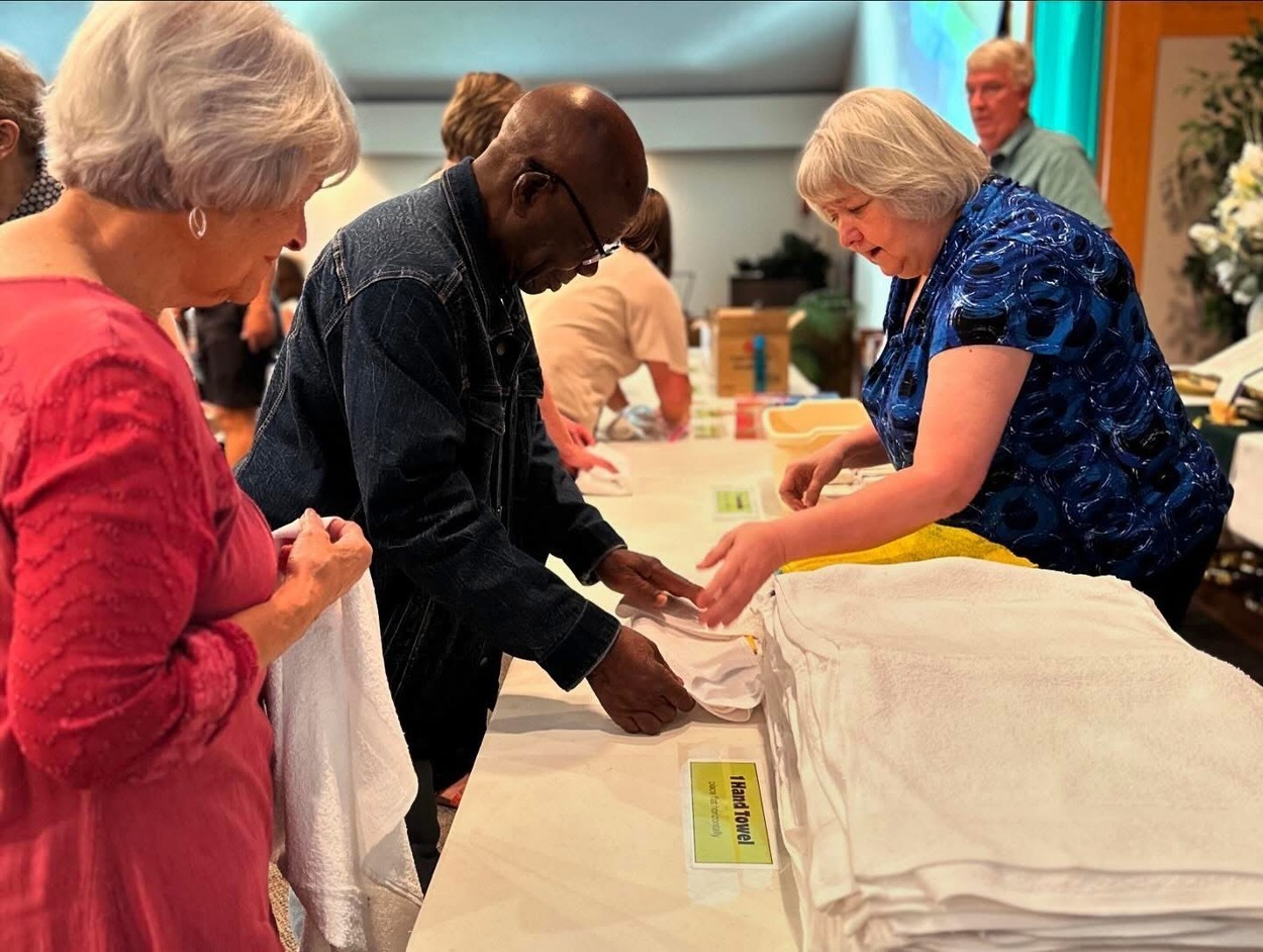 People assembling kits on a table