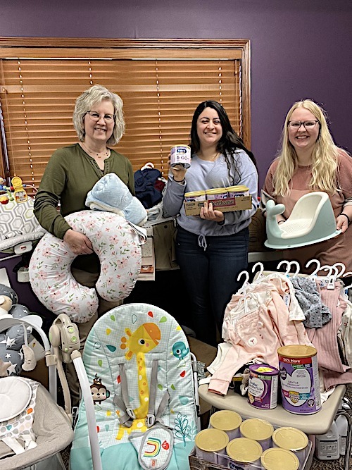 3 people amid baby supplies
