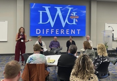 People seated listening to panel presentation