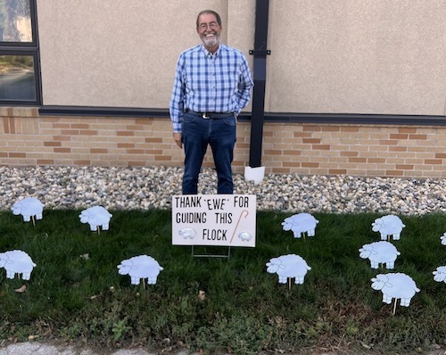 Jan gross standing by paper sheep