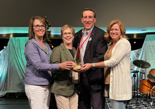 Four people with award