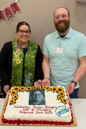 Two people with sheet cake