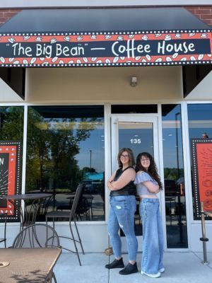 Two women in front of coffee shop