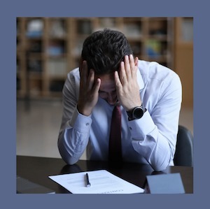 Man sitting with head in hands