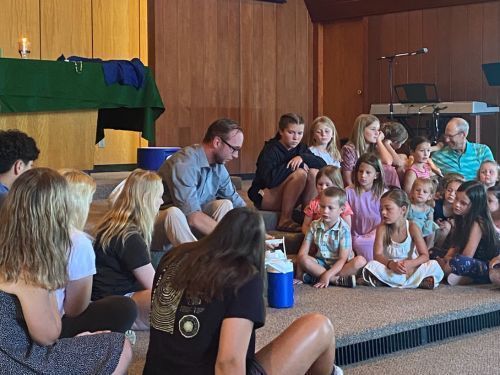 Counselor and kids on church chancel