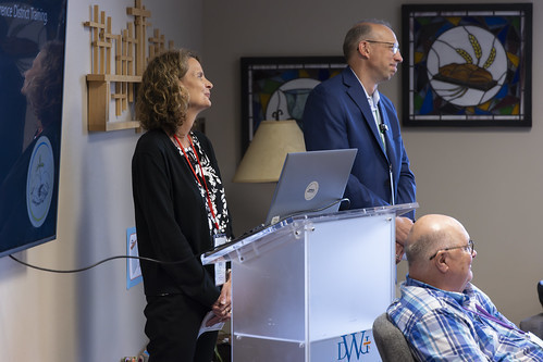 woman and man standing at podium