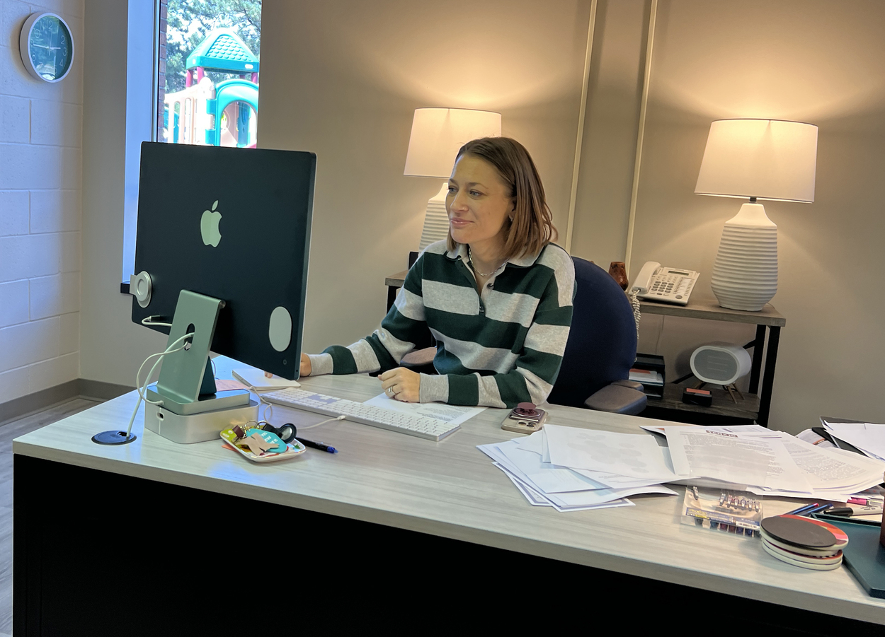 Woman smiles working at computer
