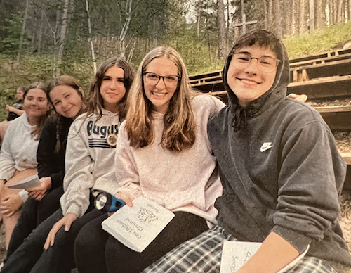 Five youth on camp bench