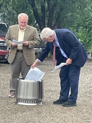 Two men burning paper
