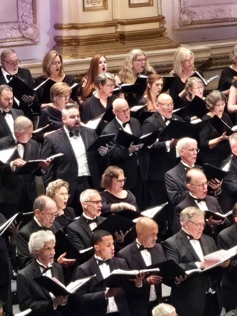 Men and women singing in large choir