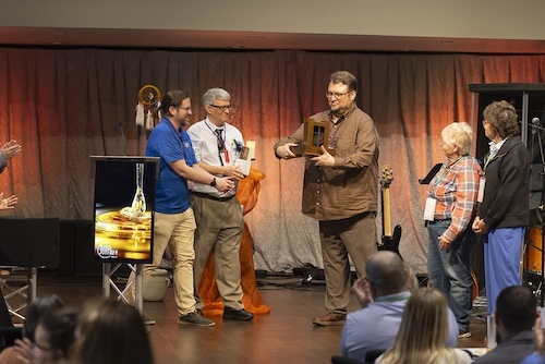 three pastors with award