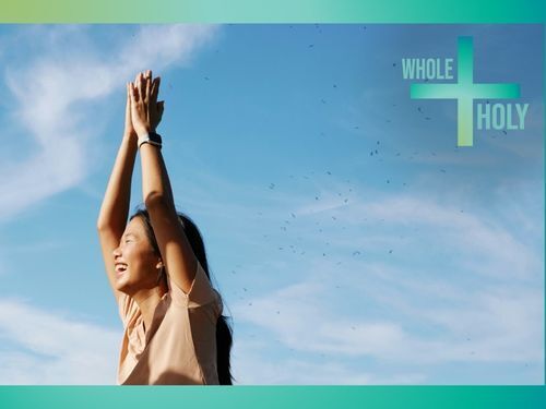 smiling person with hands raised