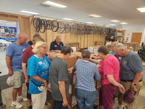 Group praying over kits